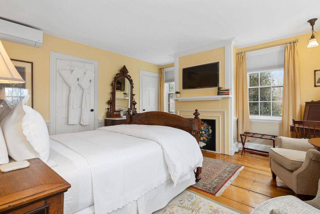 A main level room featuring a Queen-sized bed, 200-year-old wide wood planked floors overlooking Old King’s Highway