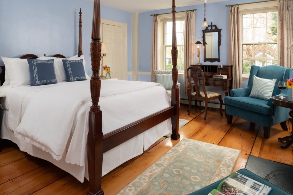 gloriously hand-carved, four-poster, and amazingly comfortable Queen-sized bed, the inviting fireplace, cozy chairs for reading or relaxing, the recently refinished 200-year-old wood floors