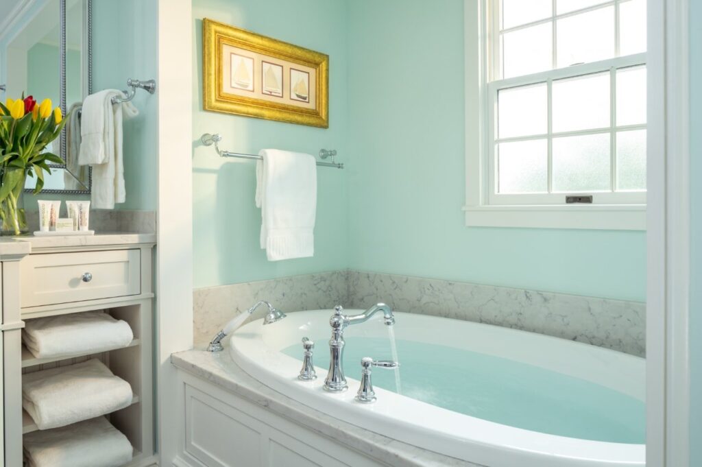 bathroom with robes and soaking tub