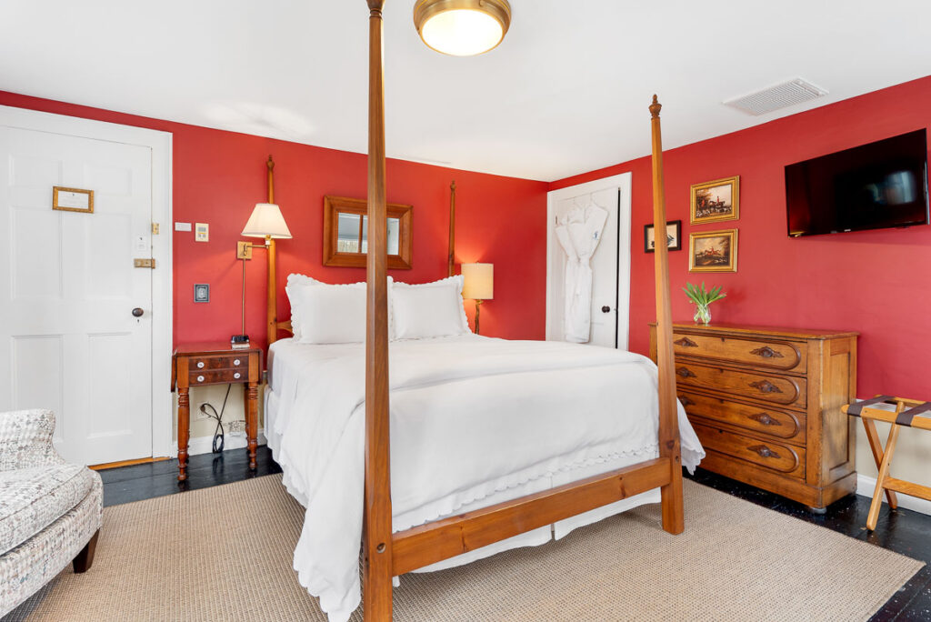 The Highlands Room offers a Queen-sized, four-poster Shaker bed, wood burning fireplace, and views of the west and front gardens.