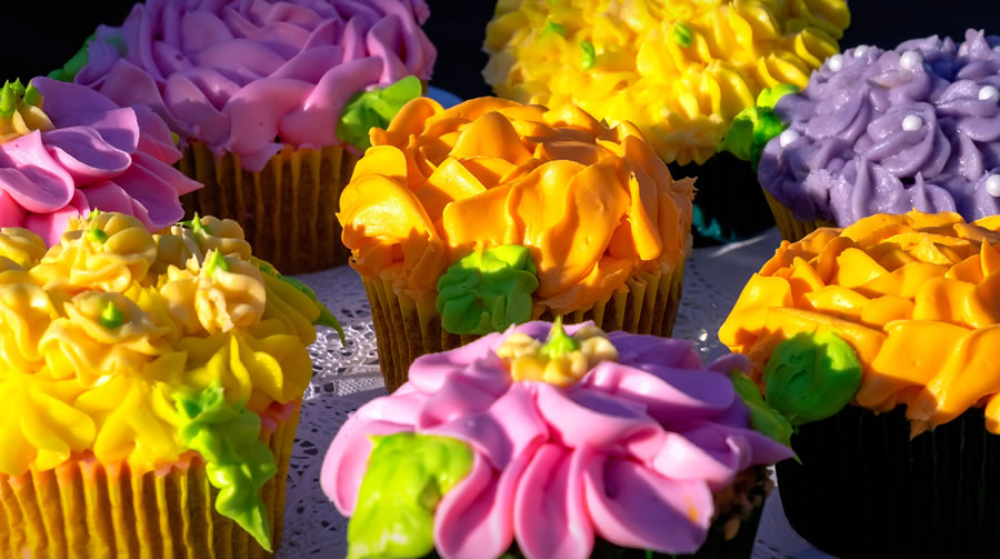 colorful cupcakes with decorative icing on top