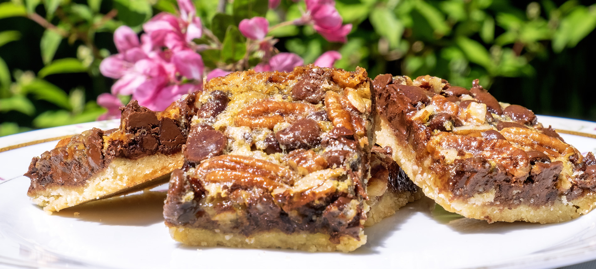 pecan bars with flowers in background